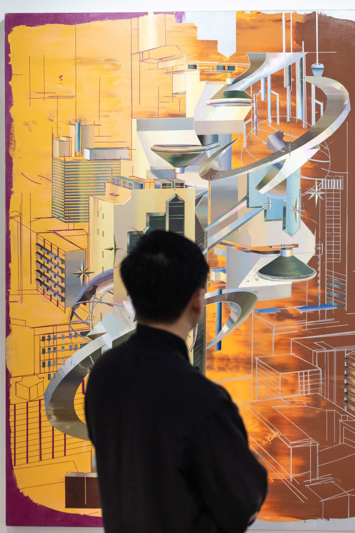 A viewer in front of a work by Cui Jie, presented by Antenna Space at Art Basel Hong Kong 2024. 