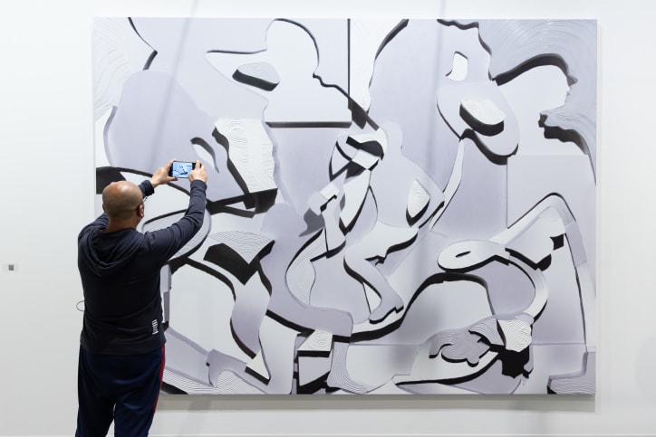 A visitor in front of a work by Alexander Carver, presented by Kraupa-Tuskany Zeidler at Art Basel Hong Kong 2024. 