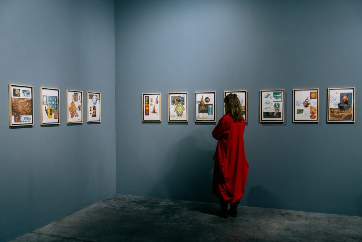 A visitor in Galeria Isabel Aninat and Espacio Verde's booth in the Nova sector at Art Basel Miami Beach 2025.