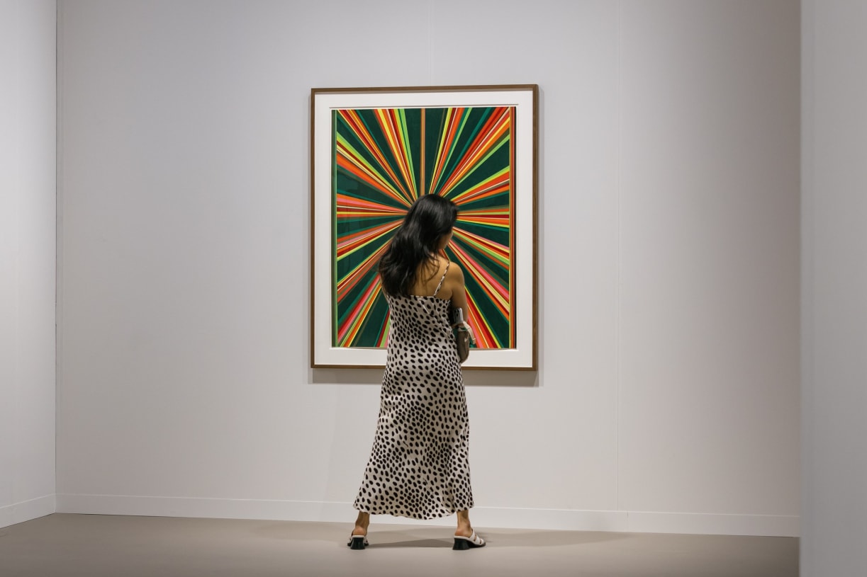A visitor in Galerie Max Hetlzer's booth at Art Basel Miami Beach 2025.