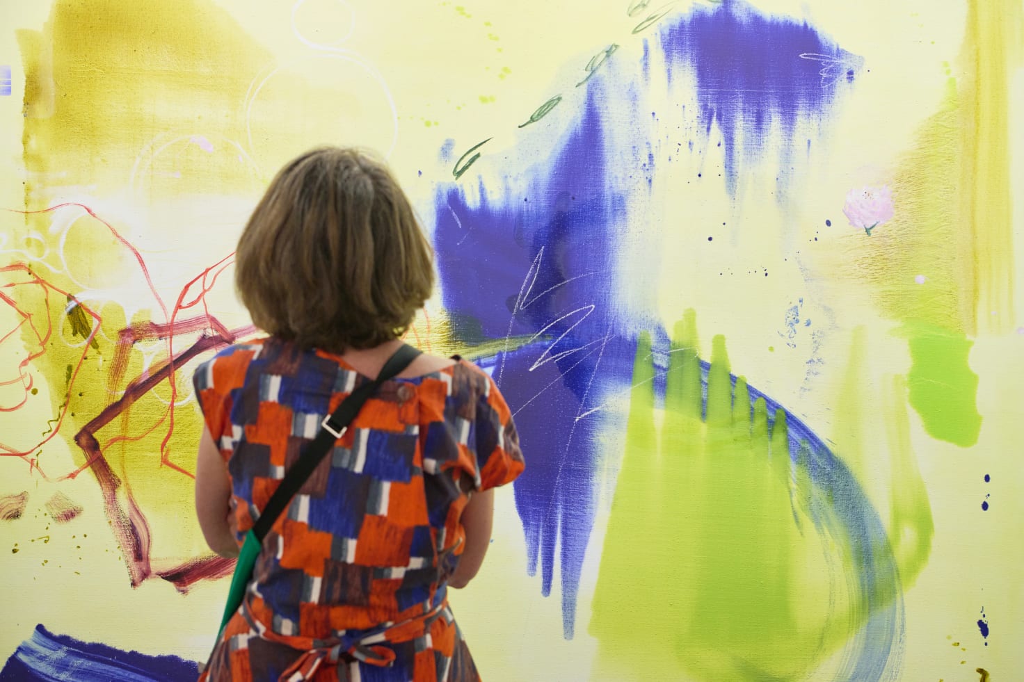 A visitor in front of a painting by young artist Emma McIntyre, exhibited by David Zwirner at Art Basel in Basel 2024. McIntire started working with David Zwirner in 2024; the gallery will present a solo presentation of her work at its Hong Kong location during Art Basel in March.