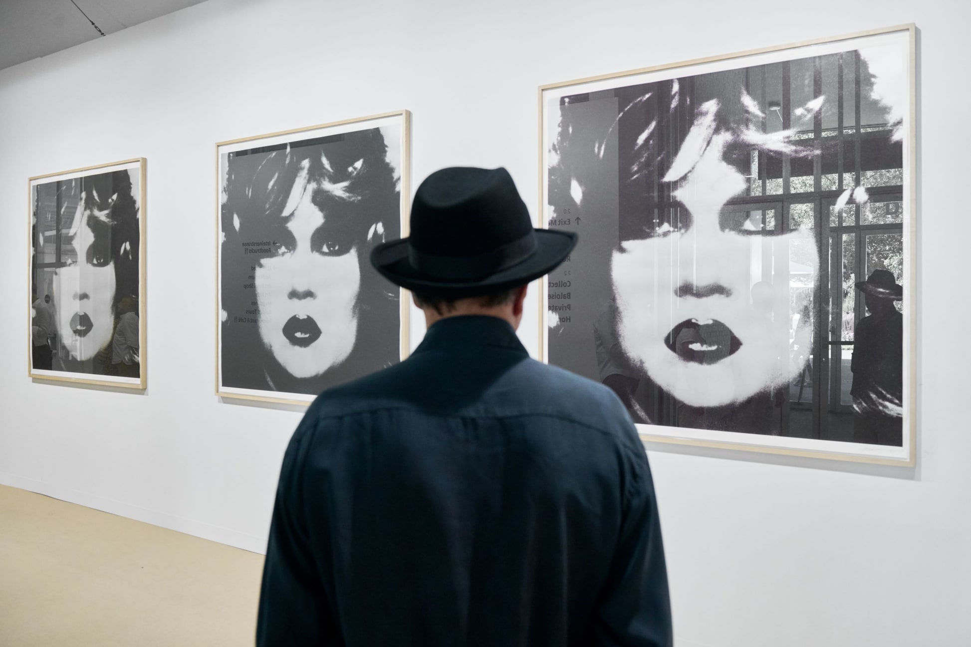 A visitor in front of an editioned work by Katharina Sievering, presented at Art in Basel 2025 by Knust Kunz.