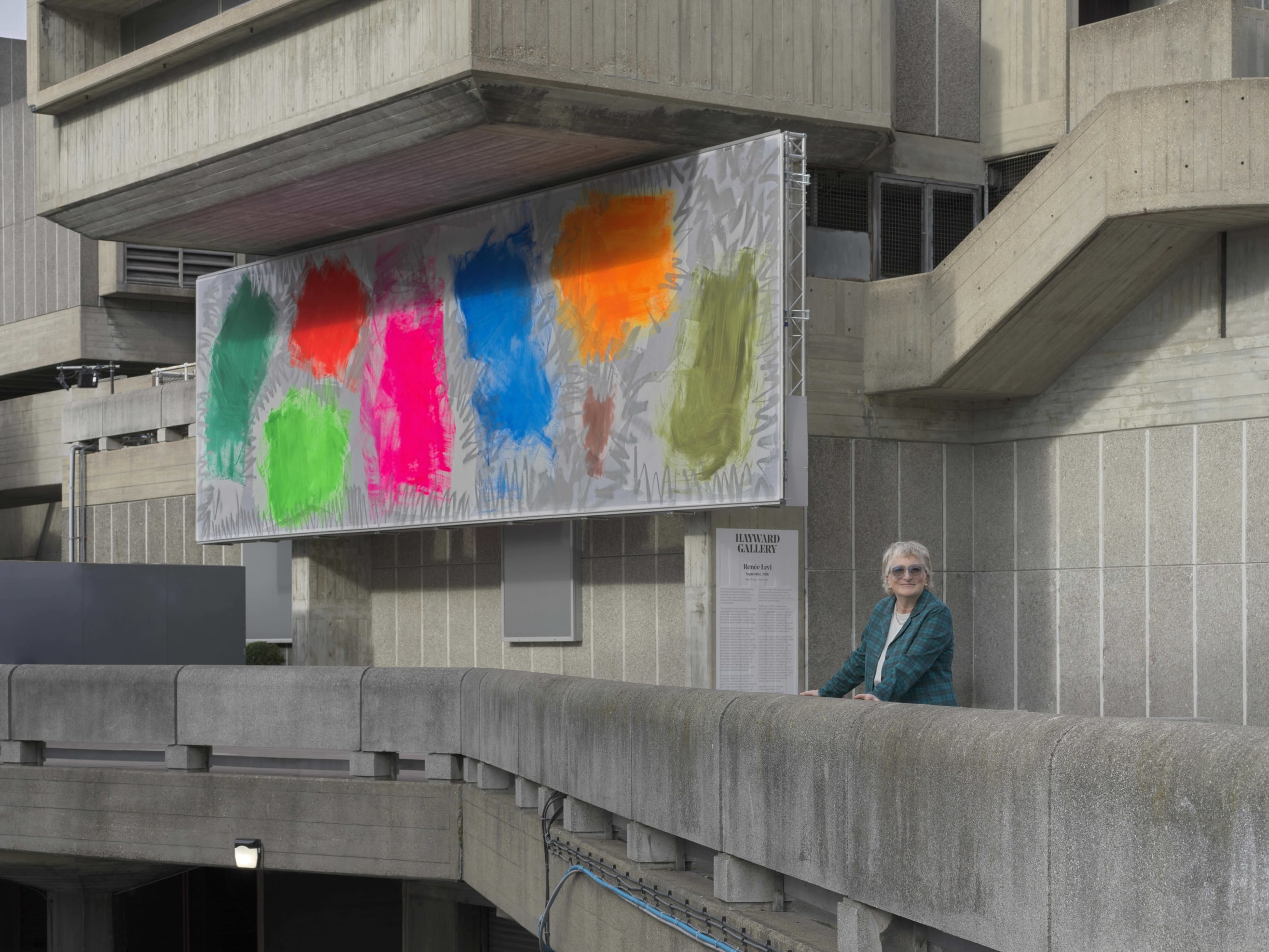 Renée Lévi alongside her site-specific facade work, September, 2026, at the Hayward Gallery.. Photography by Annik Wetter.