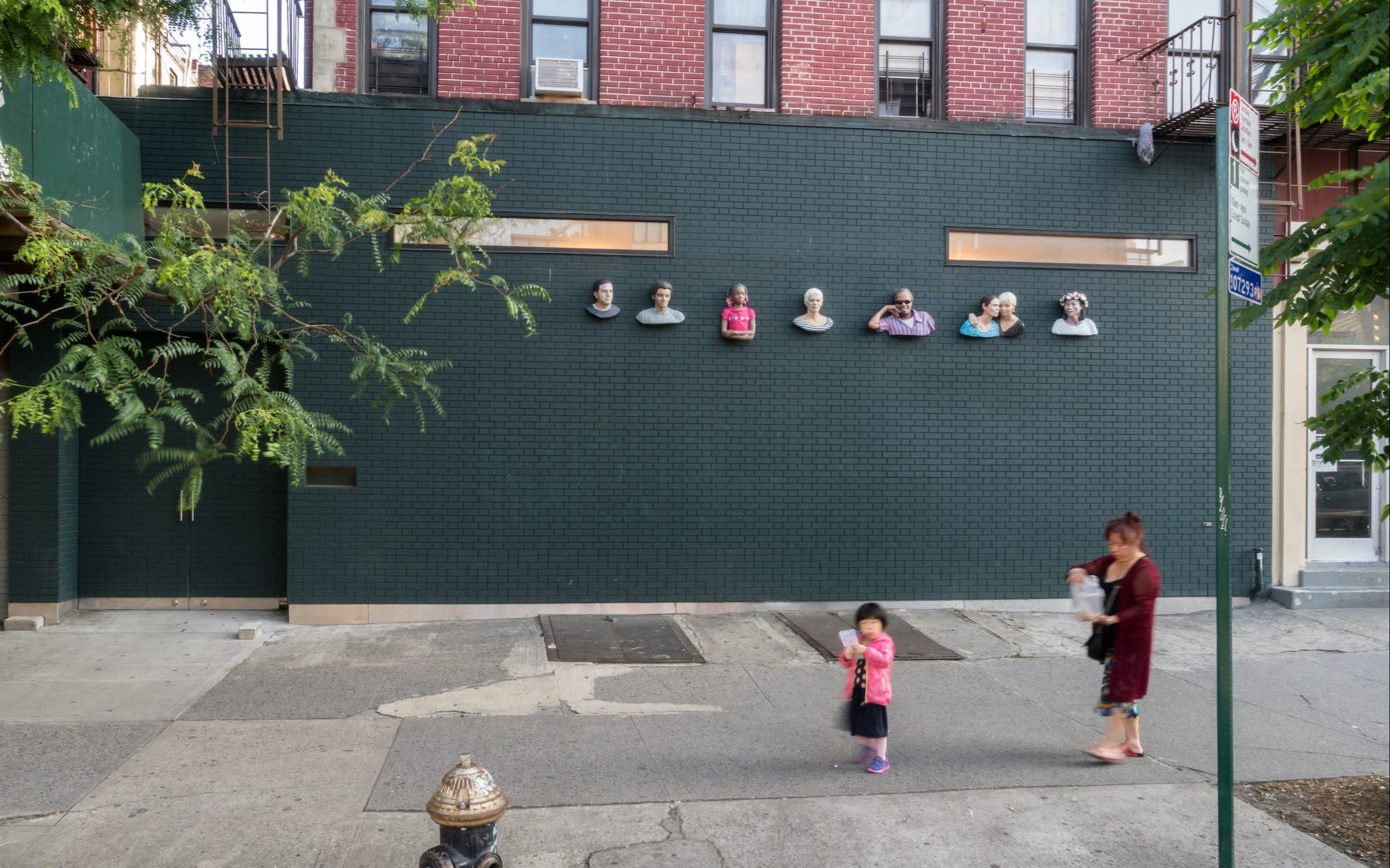 Seven sculptures by John Ahearn installed on the Lower East Side facade of James Fuentes, 2017. Photo by Jason Mandella, courtesy of James Fuentes, New York City.