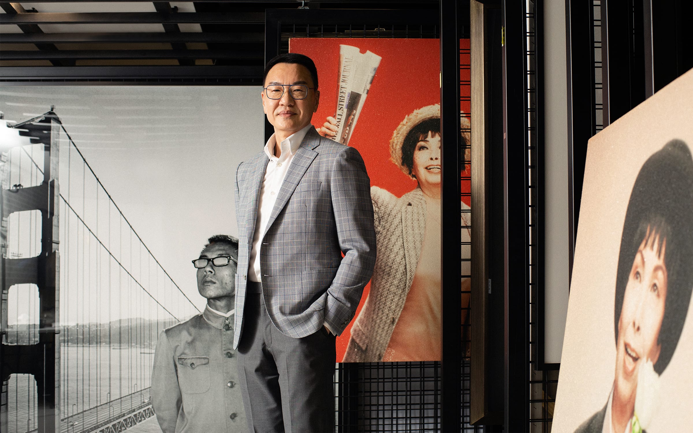 Patrick Sun in front of works by Tseng Kwong Chi (left) and Hiram To (center and right). Photo by Amanda Koh for Art Basel.
