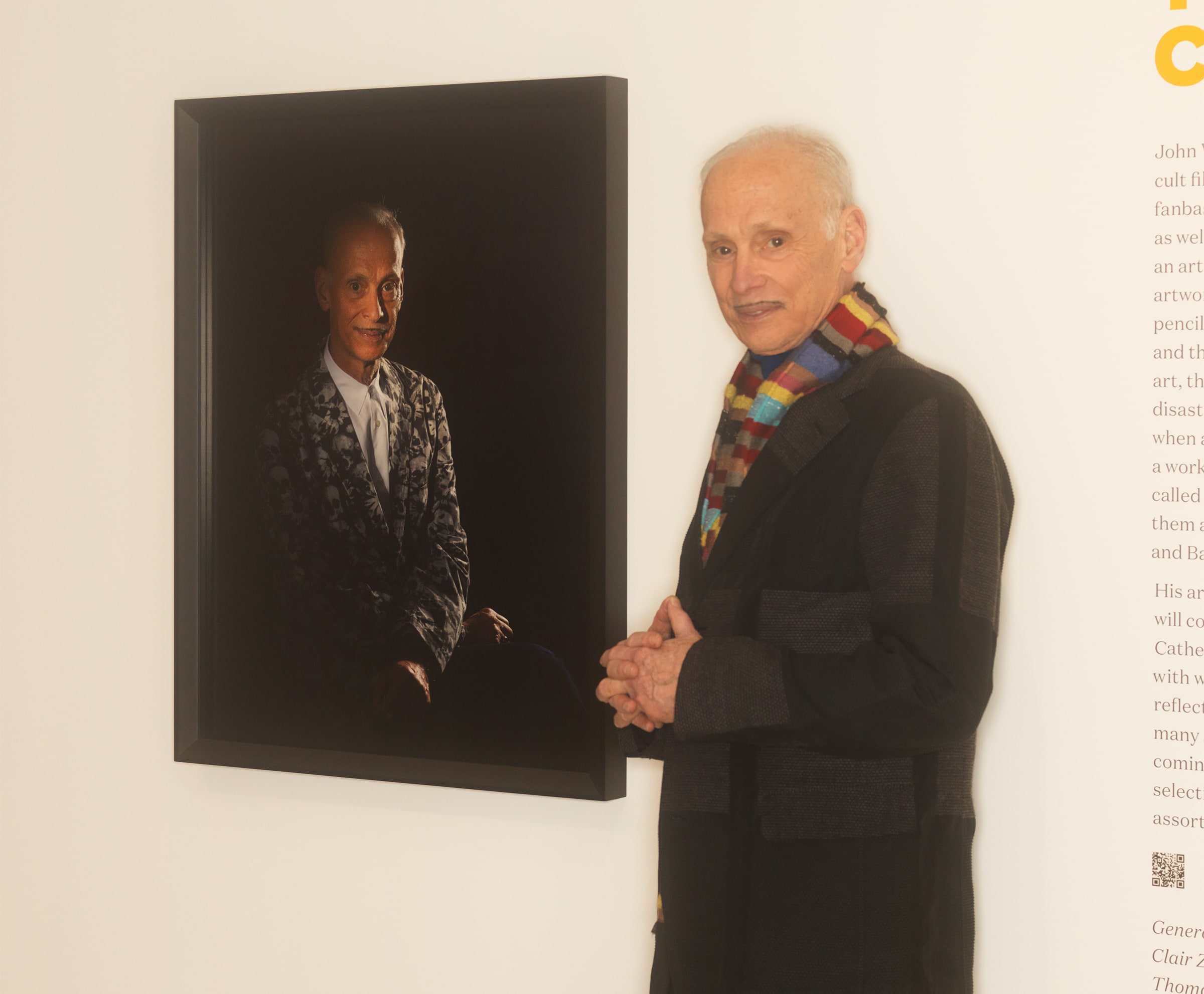 John Waters with his portrait, shot by Catherine Opie (John, 2013, printed 2022), at the Baltimore Museum of Art. Photograph by Matt Grubb for Art Basel.