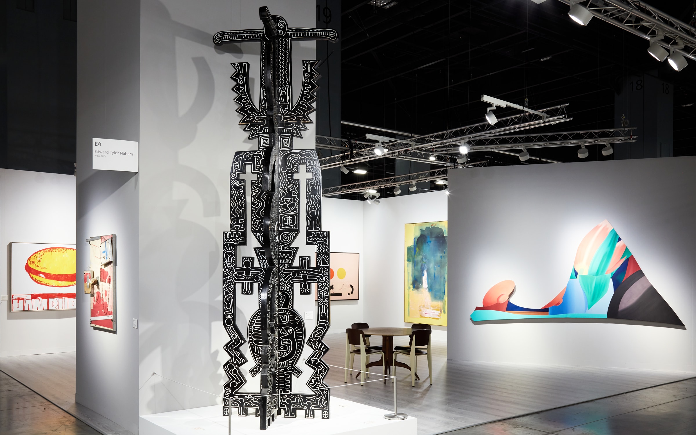 Installation view of Edward Tyler Nahem Fine Art's booth (E4). A rare totemic sculpture by Keith Haring is prominently featured at the New York gallery's stand.