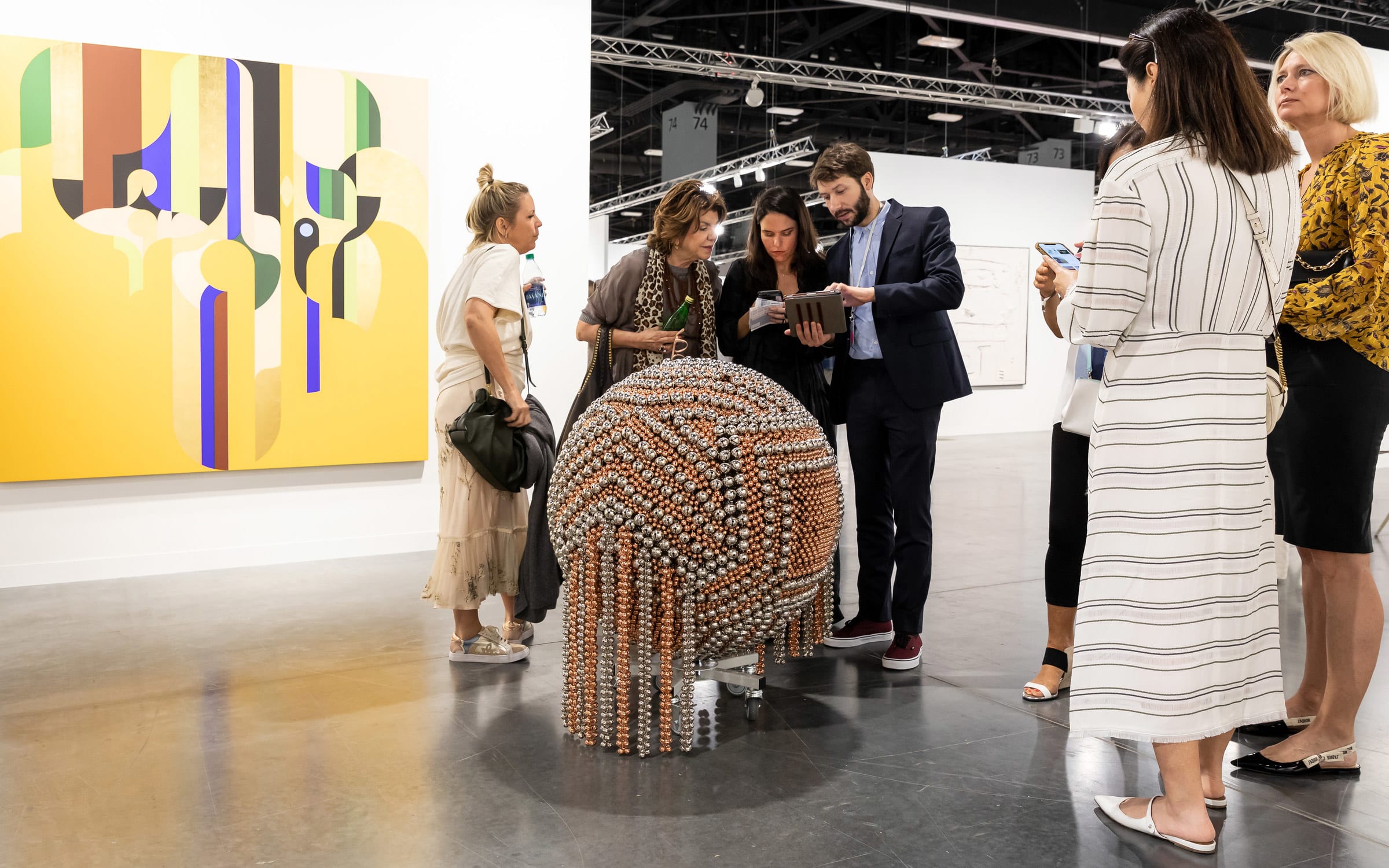Visitors at the booth of Galerie Chantal Crousel (D22).