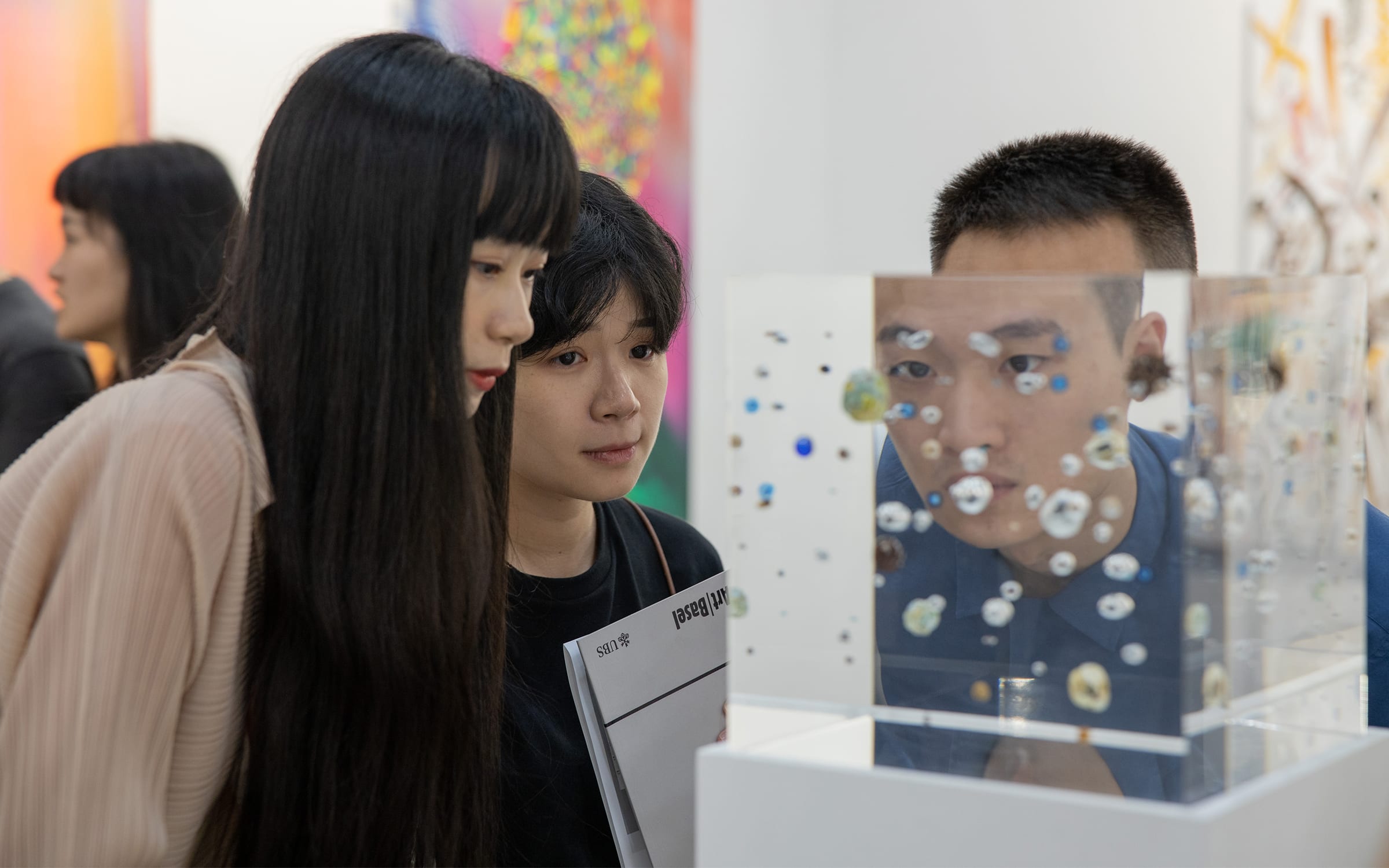 Young visitors taking a closer look at an artwork during Art Basel's 2019 Hong Kong edition.