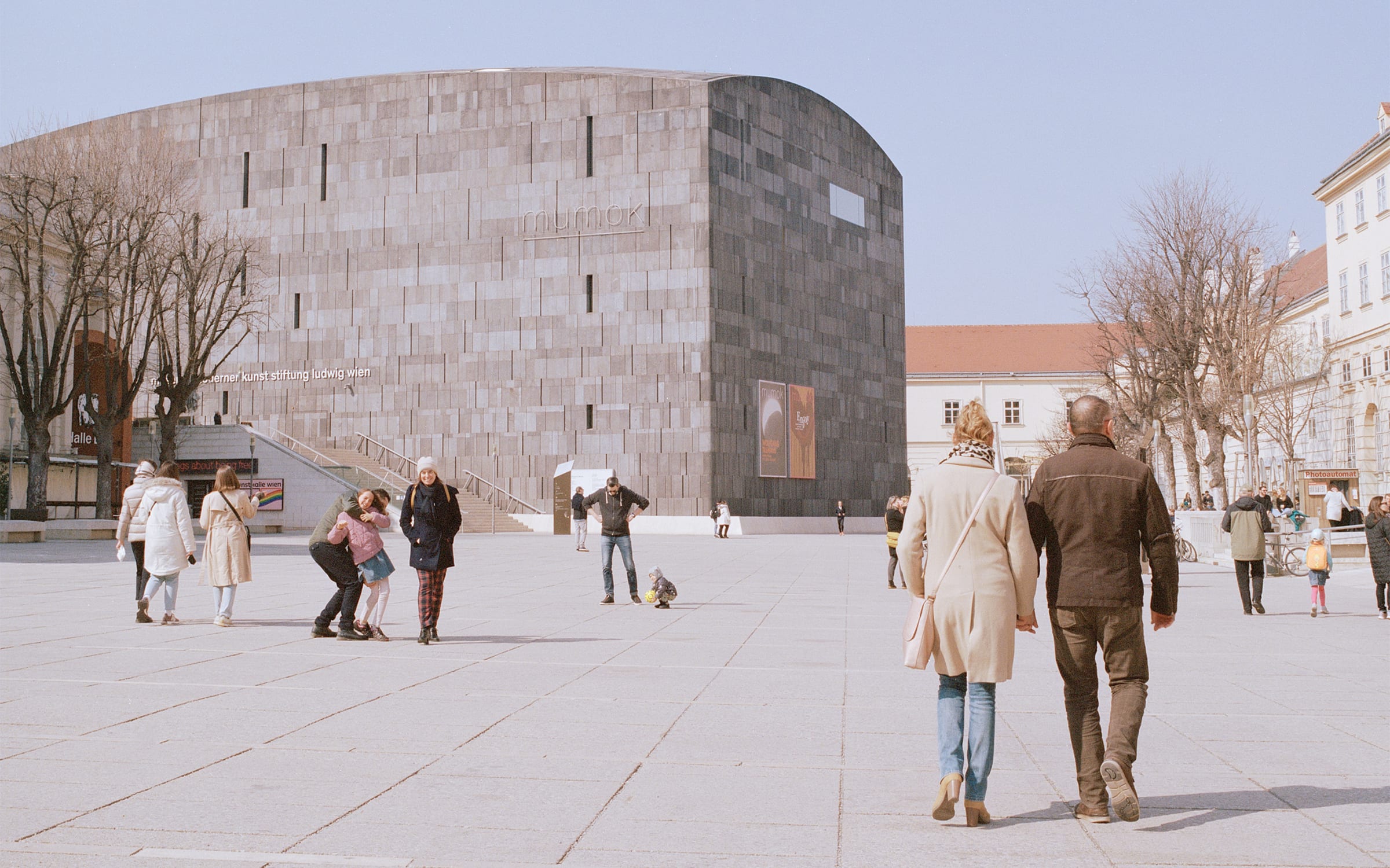 Visitors strolling through the Museumsquartier, the former imperial stables converted into one of Europe's largest museum hubs. The contemporary building houses mumok, the city's main museum for Modern and contemporary art. Photo by Verena Gotthardt for Art Basel.
