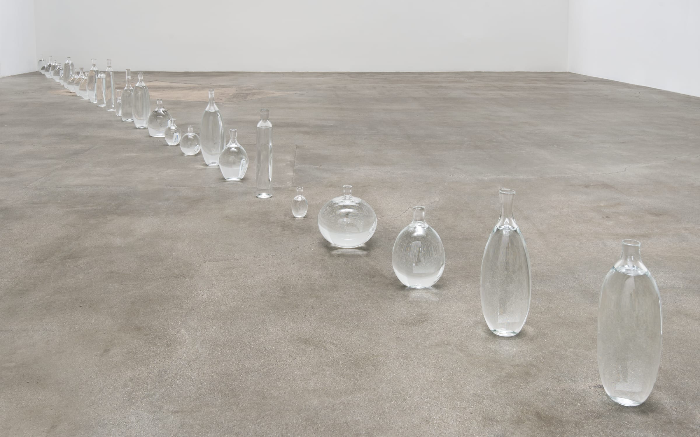 David Horvitz, Somewhere in Between the Jurisdiction of Time (2014), installation view at Blum & Poe, Los Angeles; 32 unique glass vessels holding seawater collected in the Pacific Ocean at longitude line 127.5° west, dimensions variable. Courtesy of the artist and ChertLüdde, Berlin.