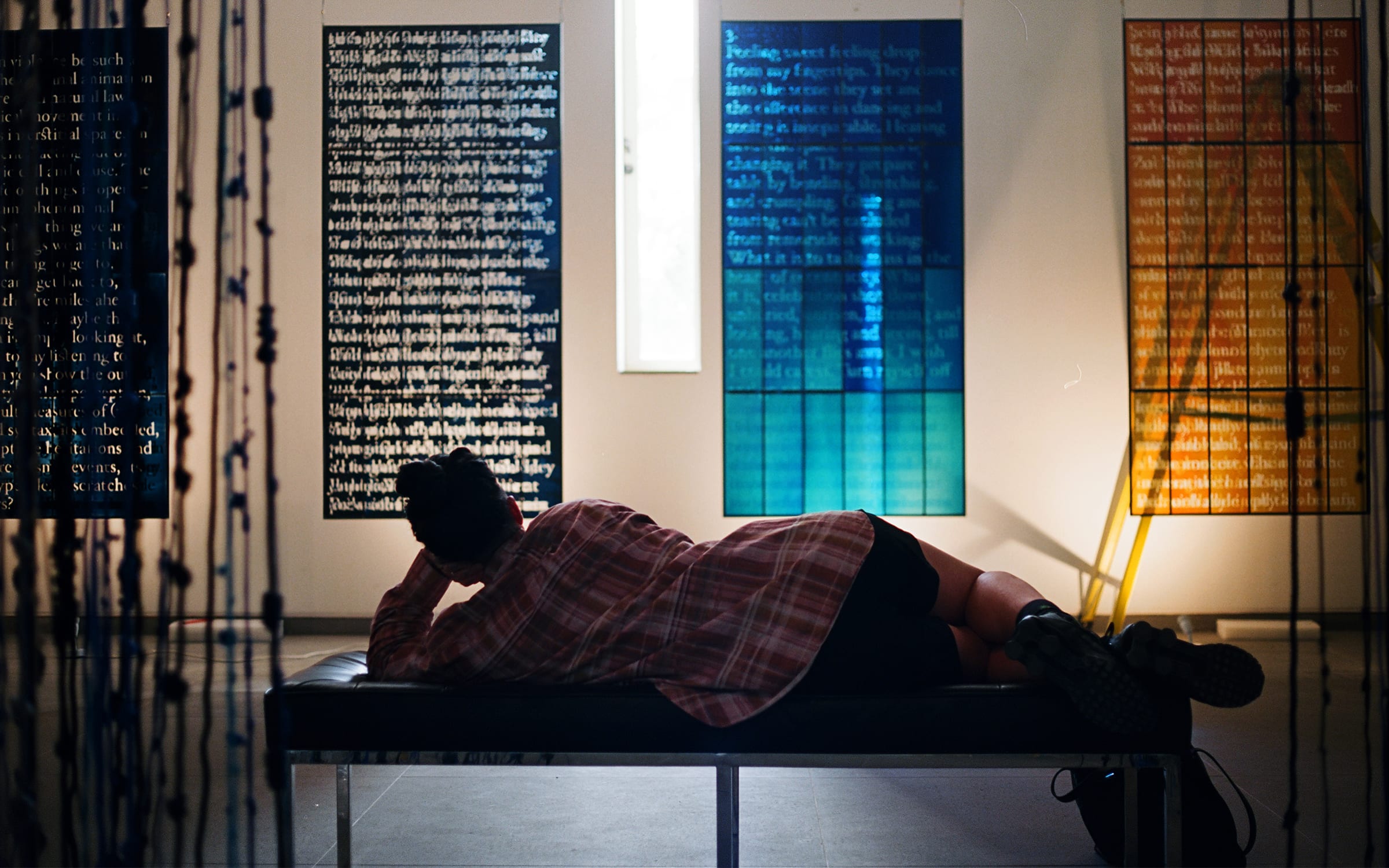 Wu Tsang, contemplating her own works in the studio. Photography by Tosh Basco for Art Basel.