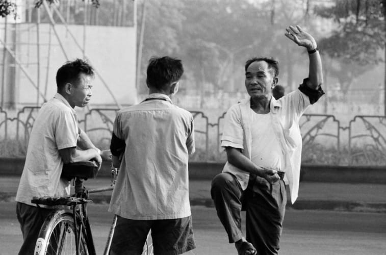 Wearing black armbands as a sign of mourning for the death of Mao, residents gather for their morning exercise. Guangzhou, 1976.