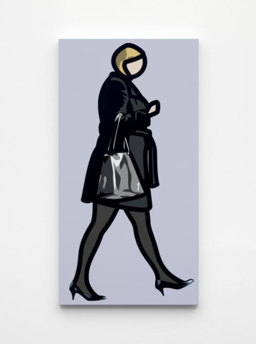 Woman in black coat with bag.