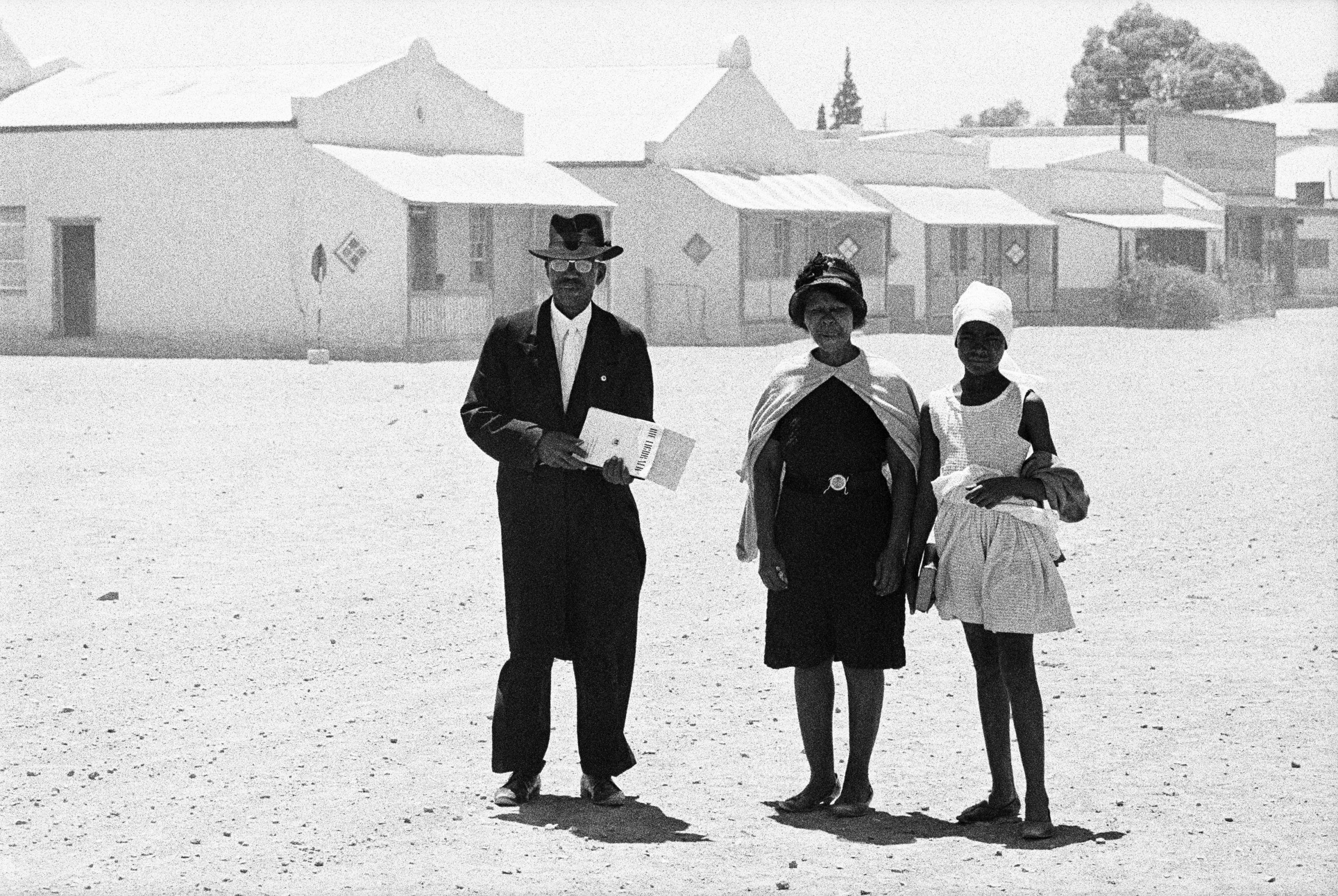 An elder of the Dutch Reformed Church walking home with his family after the Sunday service, Carnavon, Cape Province (Northern Cape), January 1968